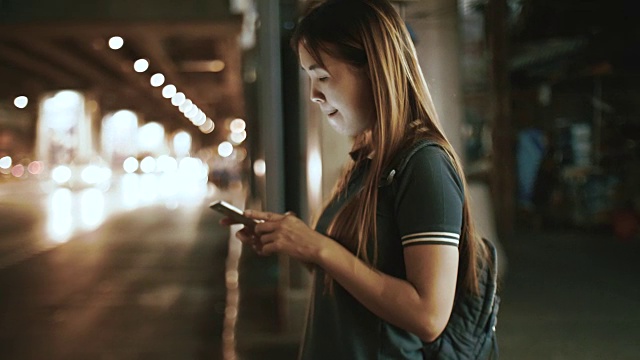 詳情圖-亞洲女性在晚上用智能手機(jī)請(qǐng)求和等待優(yōu)步