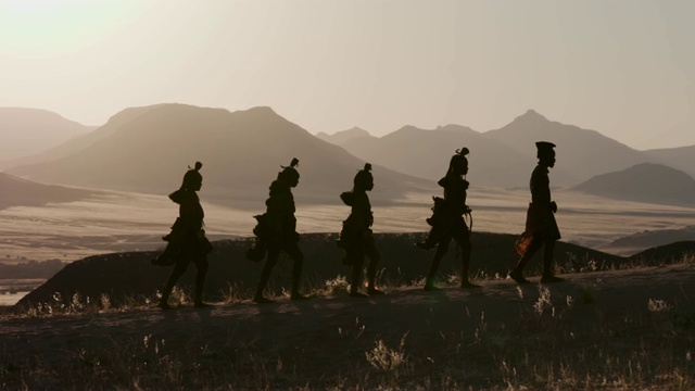 詳情圖-納米比亞納米布沙漠中，穿著傳統(tǒng)服裝的希姆巴部落的人們沿著一條以風景優(yōu)美的山脈為背景的小路行走的4K畫面