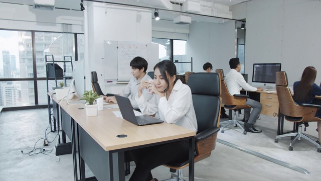 详情图-4K超高清:亚洲女员工在现代办公背景下使用笔记本电脑工作。
