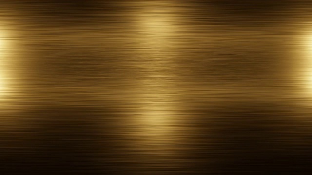 不锈钢金色金属背景纹理。光线照射在金色金属的纹理上。金属的发光和变暗。