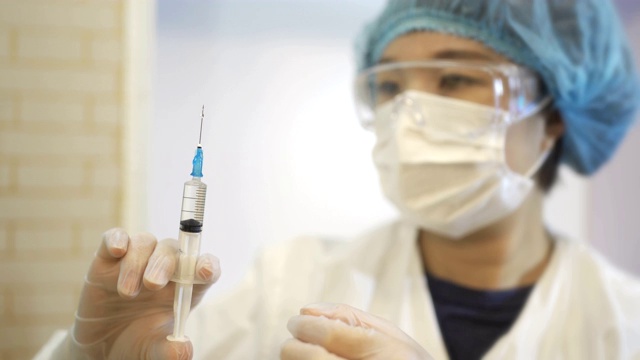 详情图-中国女外科医生检查医用注射器。