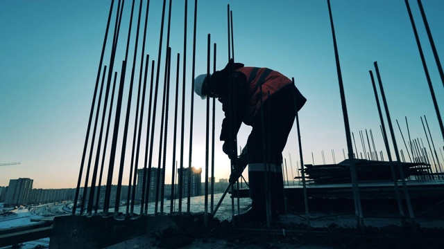 詳情圖-建筑工地的建筑工人。建筑工地和一名建筑工人正在打碎混凝土