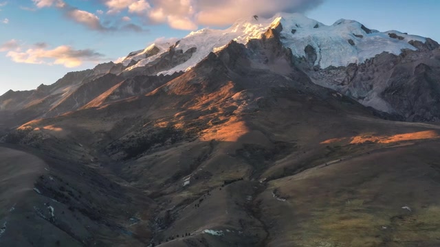 详情图-夕阳的余晖把雪山前的草原染成了金色
