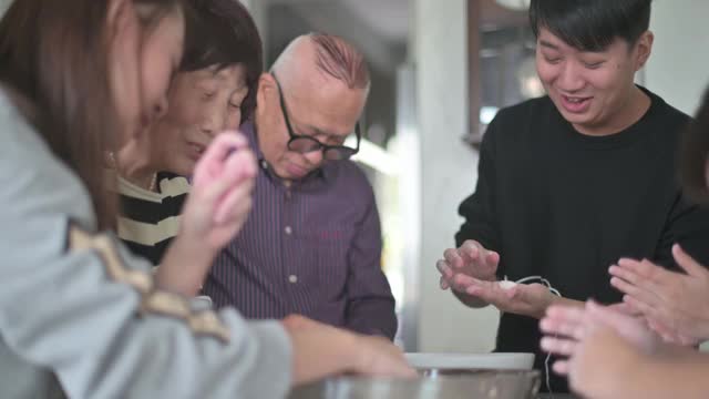 中国的老年人家庭为春节团圆饭准备中国食物“汤圆”糯米团