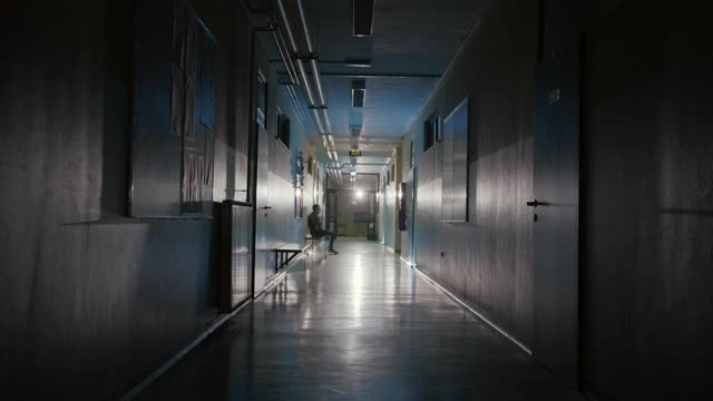 女医生告诉坐在诊所走廊长凳上的病人一个坏消息