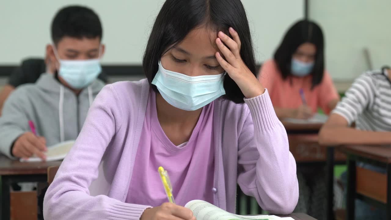 一组学生在学校教室中学泰国学生。