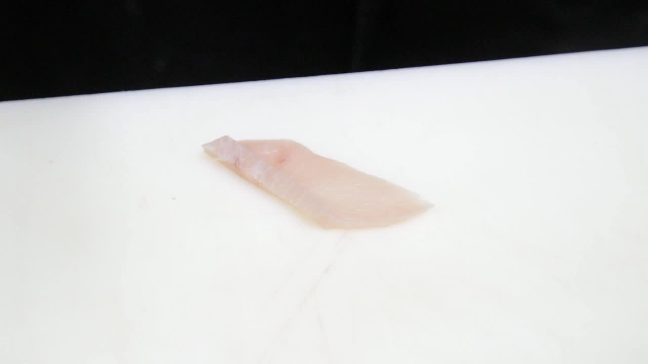 厨师用刀精细地切寿司用的金枪鱼片