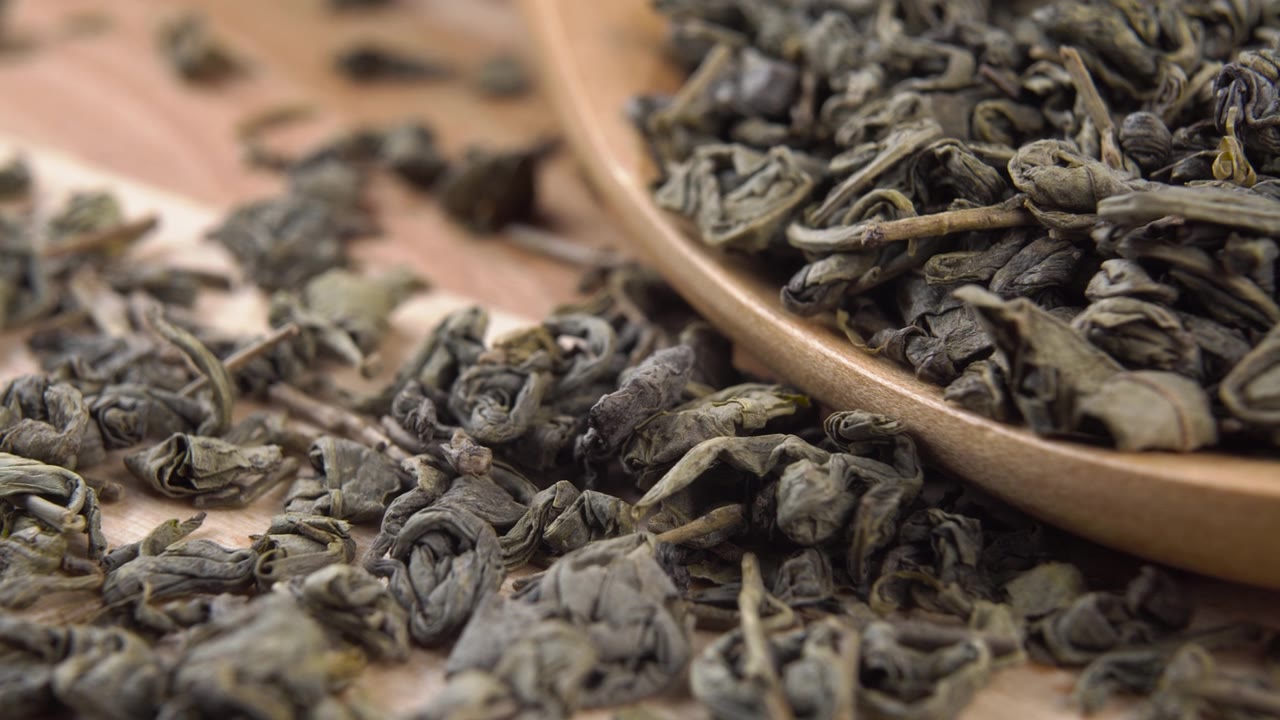 詳情圖-有機(jī)生態(tài)產(chǎn)品綠色干燥的茶葉在一個(gè)木勺在一個(gè)鄉(xiāng)村板