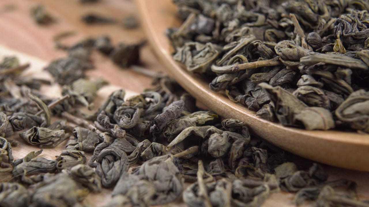 詳情圖-有機(jī)生態(tài)產(chǎn)品綠色干燥的茶葉在一個(gè)木勺在一個(gè)鄉(xiāng)村板