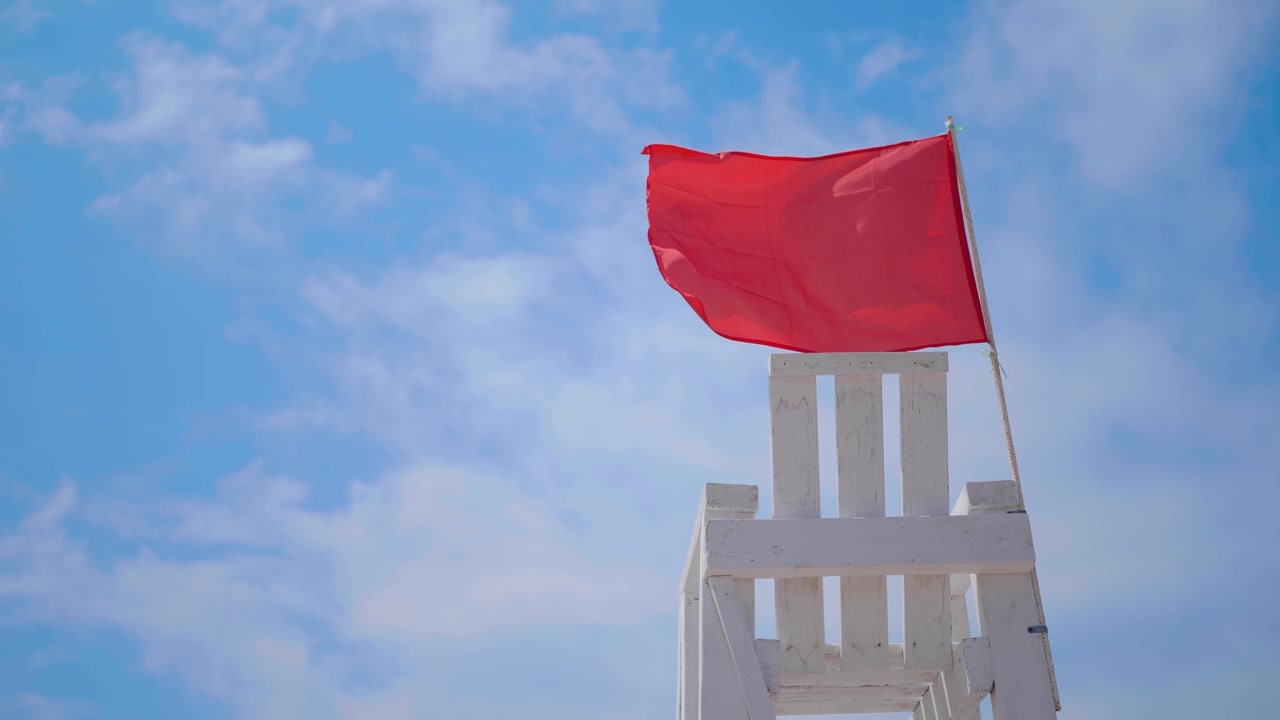 詳情圖-空的白色木制救援椅在海灘上揮舞著紅旗