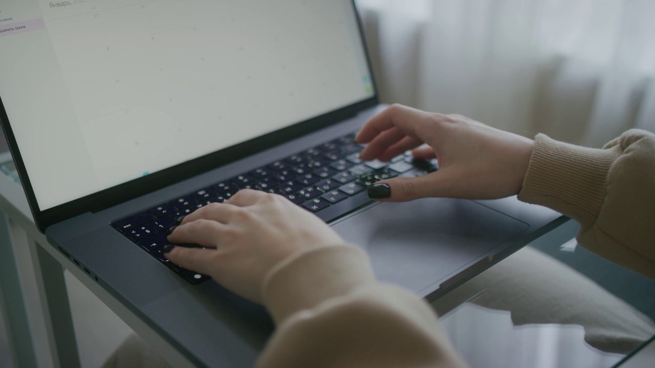 女人在笔记本电脑键盘上打字的手。正在撰写文章的记者。女士使用现代PC。女性博主家庭工作场所特写。宏。景深。4 k的片段