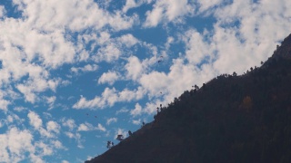在印度喜马偕尔邦的马纳里，游客们从云层前的山上跳伞。游客们从山上起飞体验滑翔伞。
