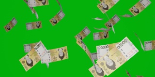 5万韩元纸币掉下来。在彩色背景上隔离的钞票。