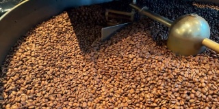 烘焙咖啡种子。在机器里磨咖啡豆的特写镜头。烹饪新鲜研磨的阿拉比卡咖啡豆的芳香味道。
