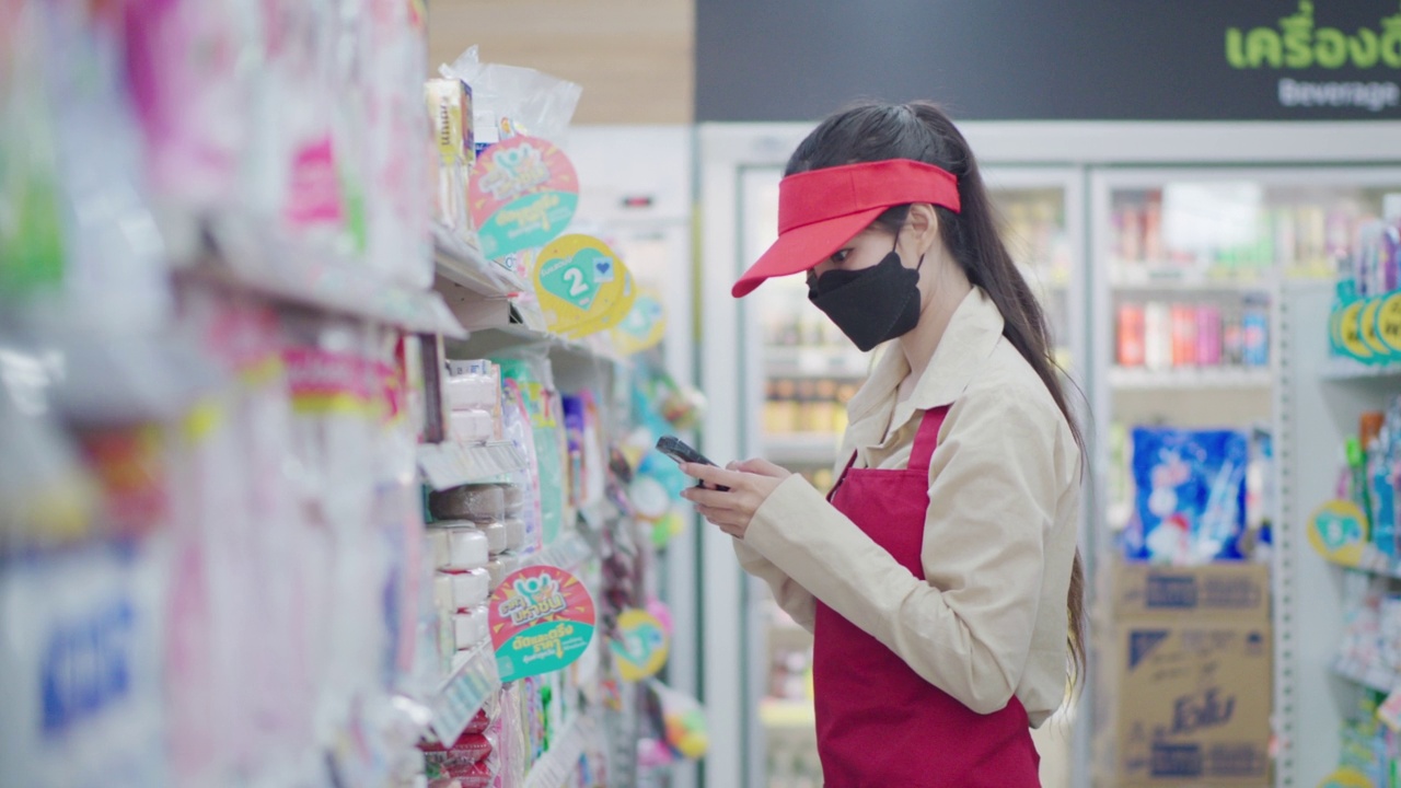 一名工人正在浏览仓库货架上商品的价格