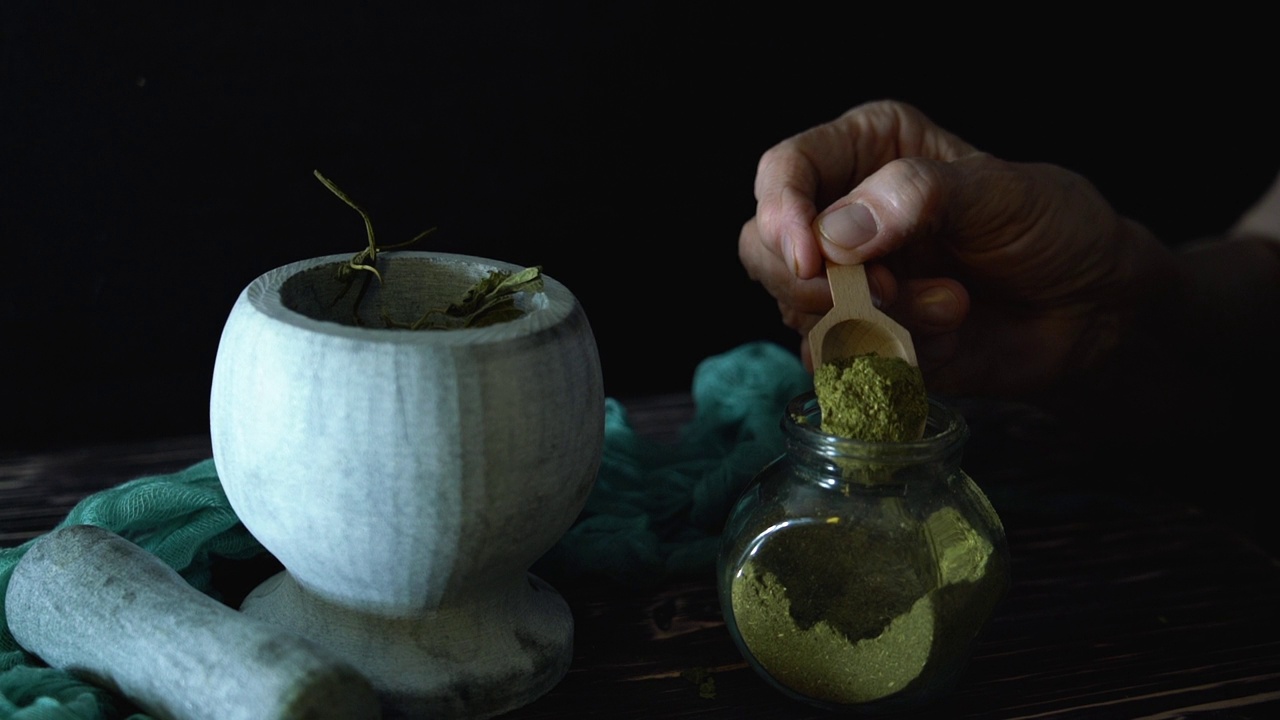 详情图-草药医生把草药洒在地上。草药的制备。