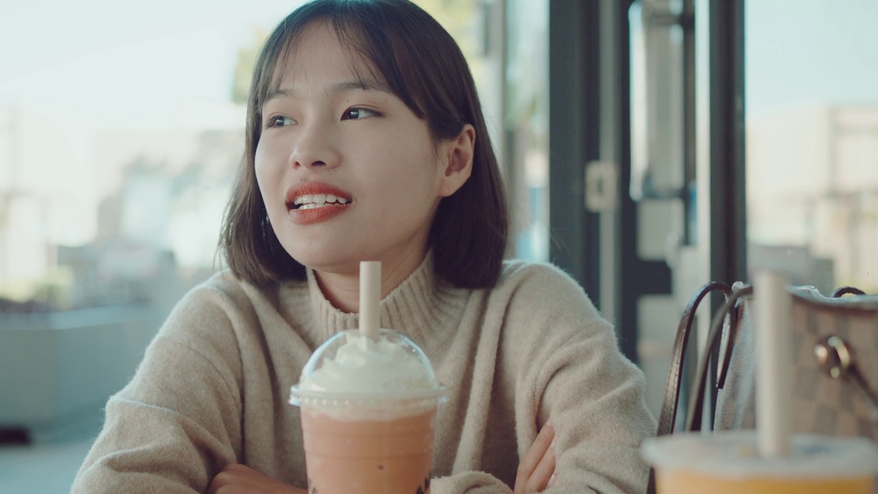 詳情圖-歡快的亞洲年輕女子和朋友在咖啡館享受她的泰國奶茶冰沙冷飲
