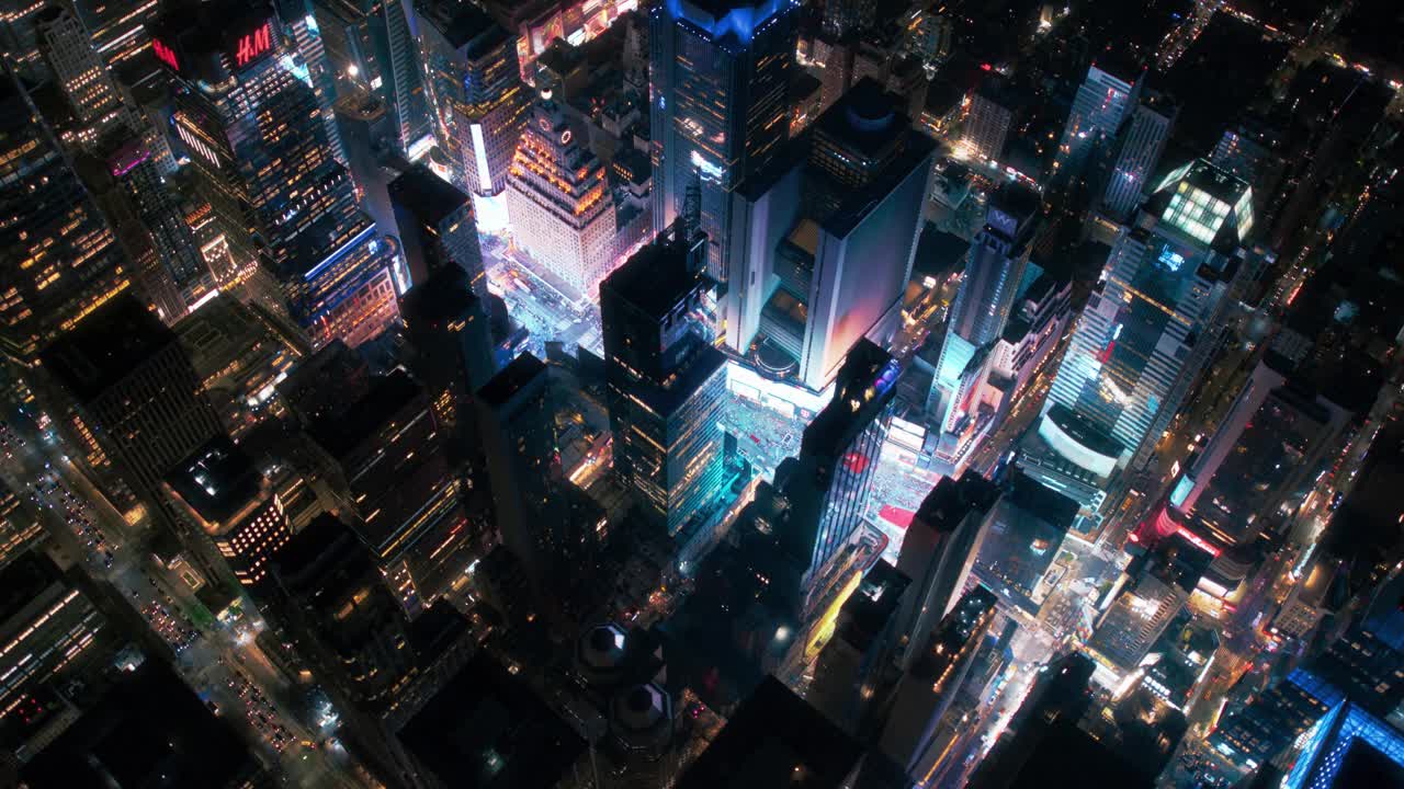 直升机夜游纽约市建筑。飞越灯火通明的时代广场，那里有五颜六色的广告牌，成群的游客享受着曼哈顿的夜生活，欣赏着这座地标