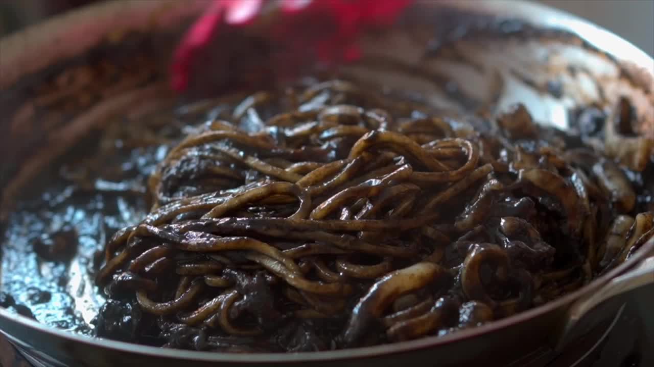在煎锅里煮墨鱼意面的慢动作