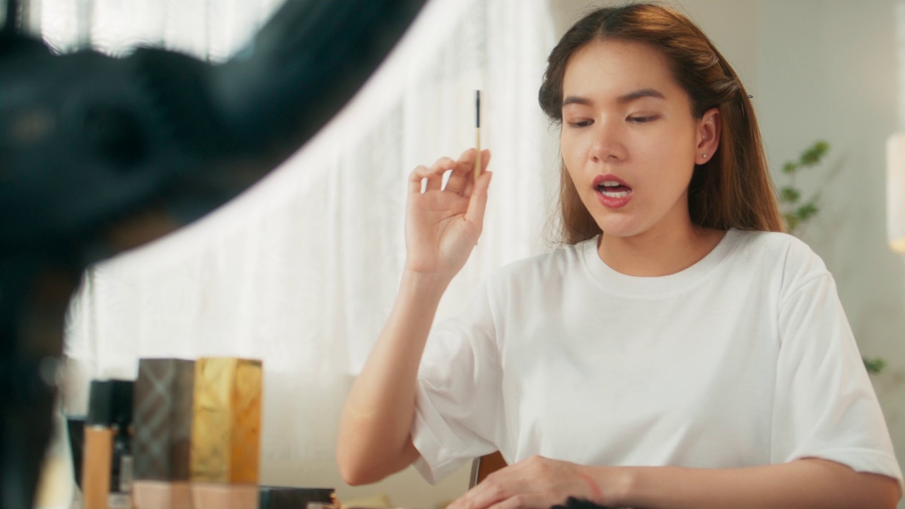 詳情圖-有吸引力的年輕亞洲女性網(wǎng)紅在移動應(yīng)用程序上在線直播分享化妝技巧