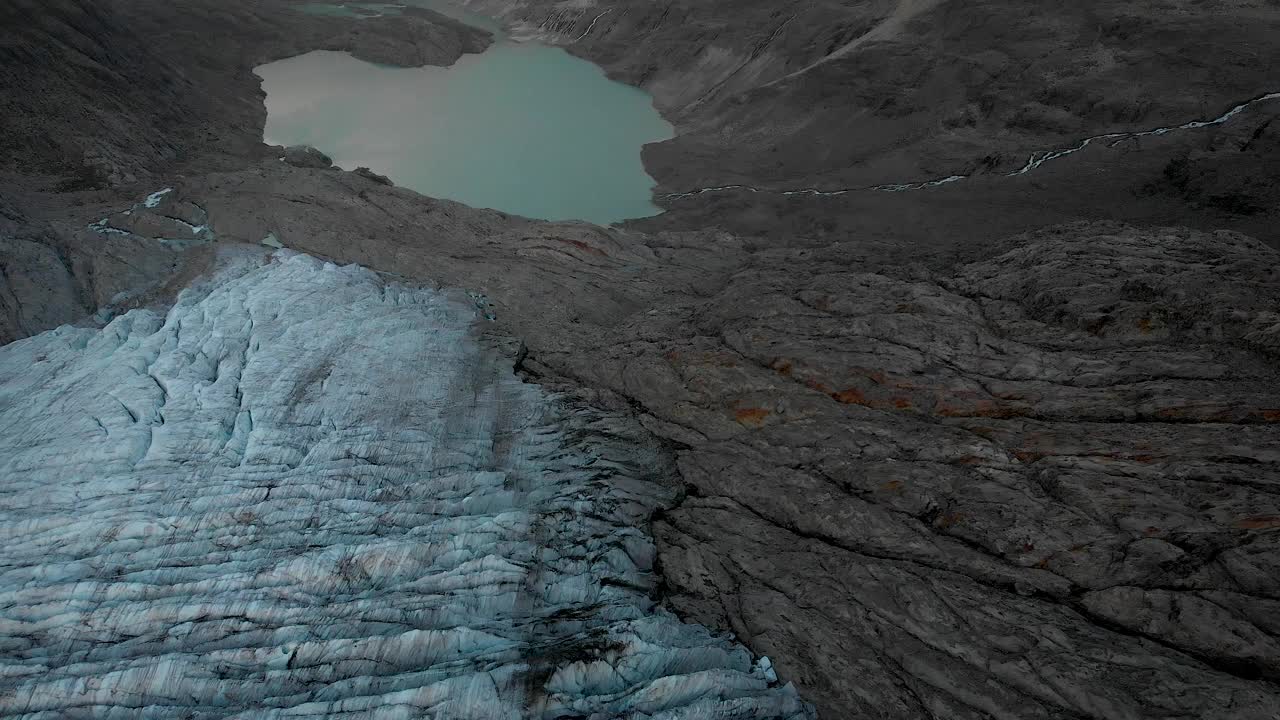 在瑞士阿尔卑斯山伯尔尼高地地区的高利冰川上空的空中飞行，从冰缝向冰川湖倾斜。