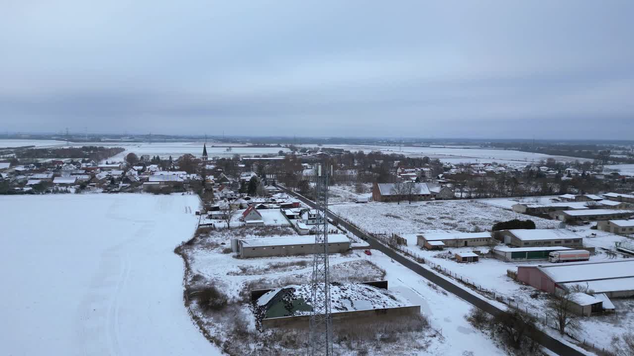 手机塔移动5G桅杆传输电话，冬雪。令人惊叹的空中俯视图飞行，在无人机上飞行4 k的片段