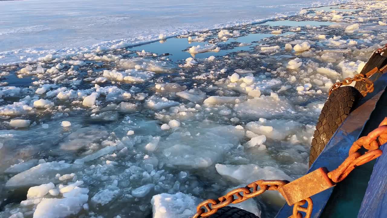 景观从一侧的河流拖船，同时移动期间的冰漂流，漂浮在河上的碎浮冰。