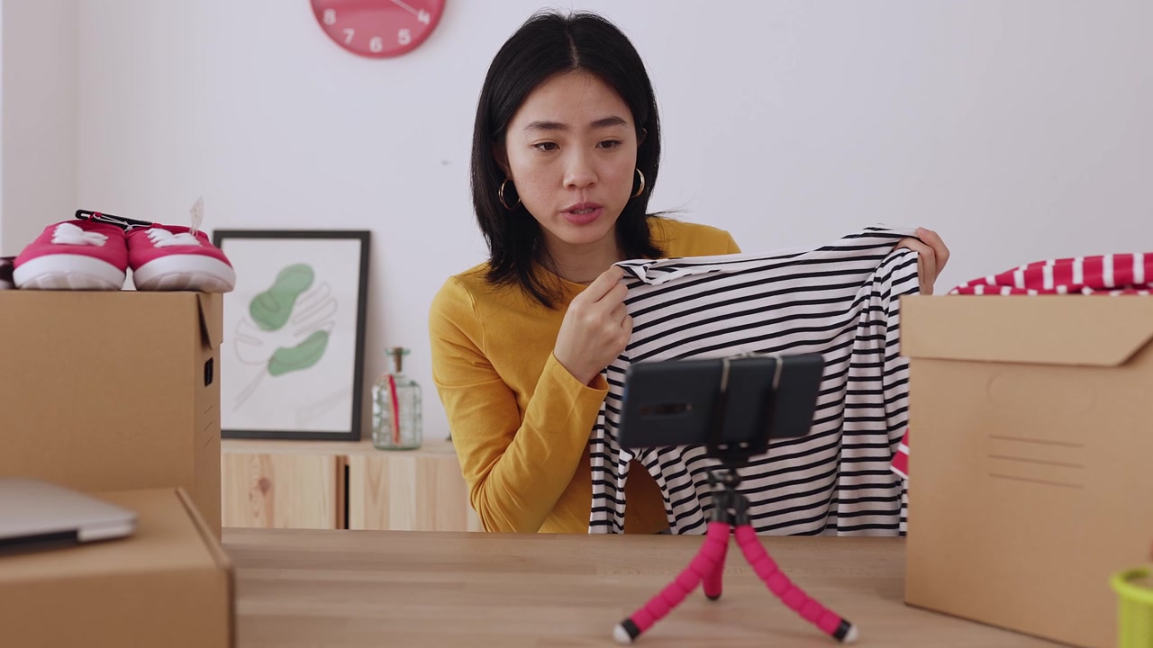 詳情圖-年輕的亞洲女性用手機(jī)拍攝關(guān)于時(shí)尚新聞和服裝產(chǎn)品的視頻