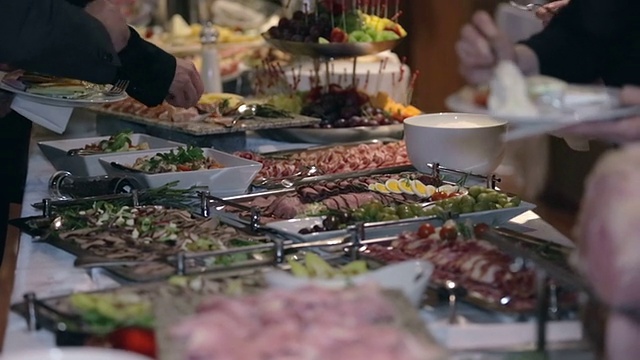 商人从餐桌上拿食物
