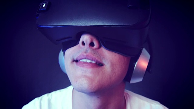 詳情圖-笑著戴VR頭戴體驗虛擬現(xiàn)實的年輕人