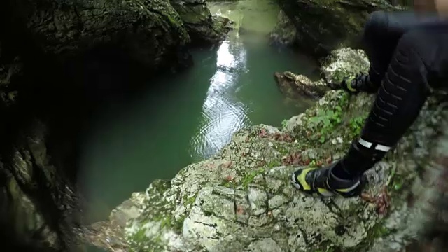 详情图-POV:不认识的人从一个高的山崖跳进清新的河流