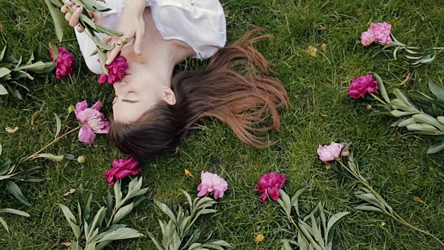 女人躺在草地上，鲜花盛开