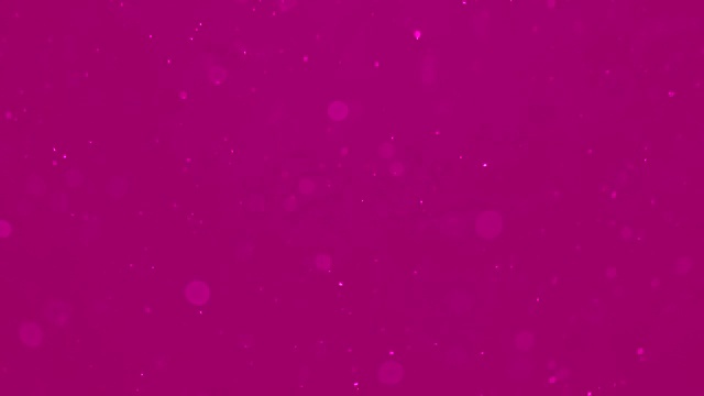 移动粒子在粉色背景上模糊