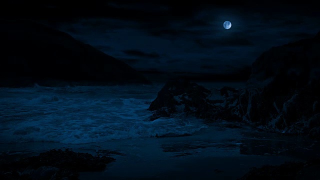 月光下岩石海滩上的波浪