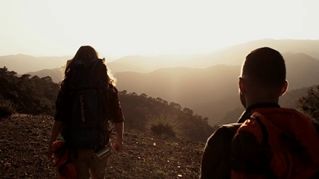 成功的女性和男性徒步旅行者到达了风景优美的山边