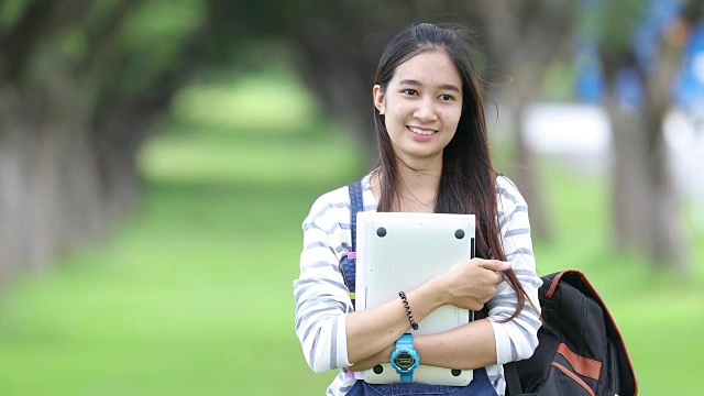 詳情圖-微笑美麗的亞洲女孩閱讀和工作在公園的樹(shù)在夏天放松時(shí)間