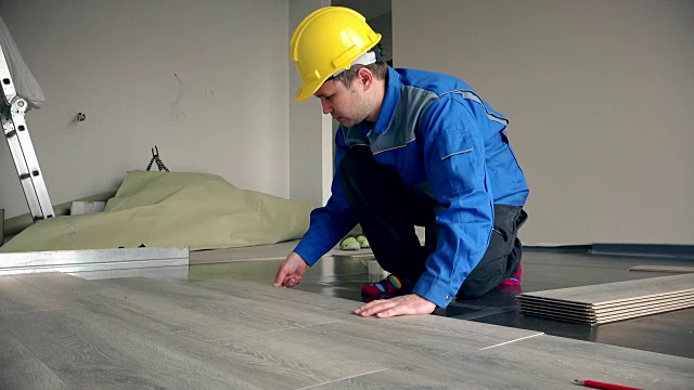 熟练的建筑大师铺设木地板