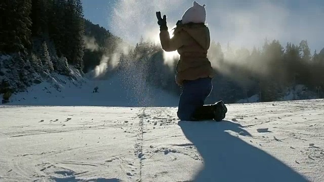 女孩在公园里抛雪，在阳光的照射下，慢镜头