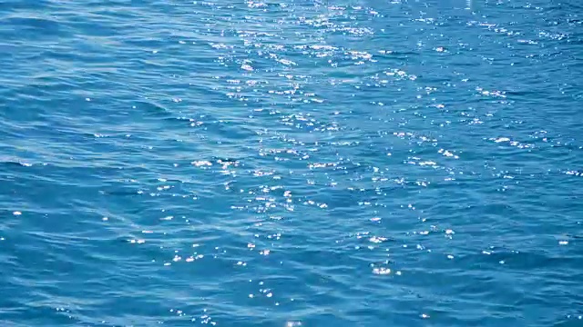 夏天，海面上，波涛汹涌，太阳的光线都反射在水面上