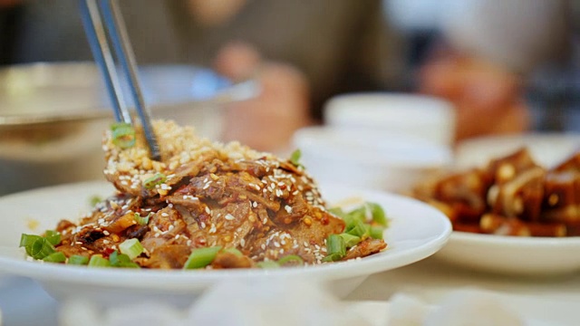 一个用筷子吃正宗中国菜的特写。中餐厅与食物概念