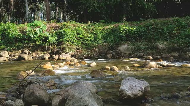 在泰国董里，阳光从瀑布中流过，在树荫下遮荫