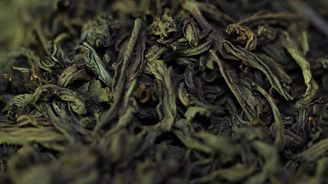 詳情圖-茶藥材質地。綠茶。有機干綠茶葉。一堆干綠茶的背景。宏