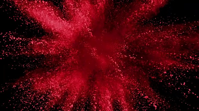 红色粉末在黑色背景上以超慢镜头爆炸