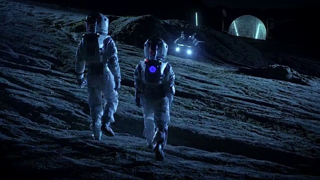 詳情圖-下面是兩名宇航員穿著太空服行走在外星星球上仰望天空的照片。在背景基地與球型圓頂。其他世界殖民和太空旅行的概念。