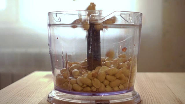 用刀把烤花生放在搅拌器里焯一下。用搅拌机、搅拌机制作花生奶油。缓慢的运动。