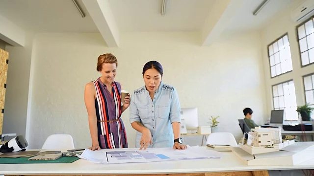 女人们在建筑公司明亮的自然光线下开会