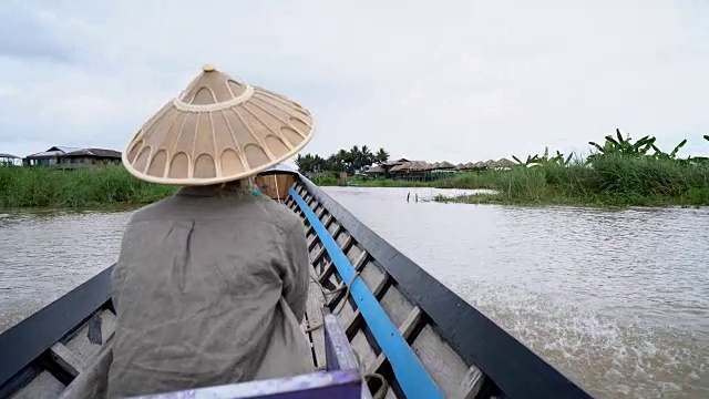 年轻女子在亚洲旅行，出租车上坐着白种女子的长尾木船