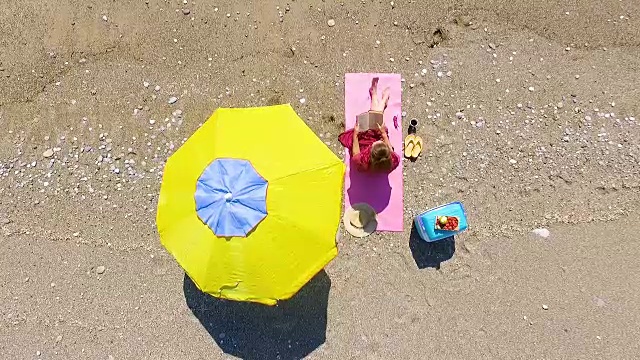 在沙滩上看书的美女