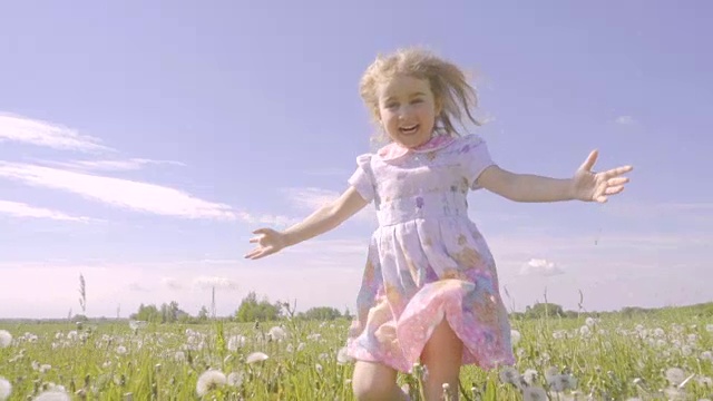 詳情圖-可愛的小女孩在蒲公英色的草地上奔跑。孩子們在戶外歡聲笑語。夏天陽光燦爛的日子。緩慢的運動。