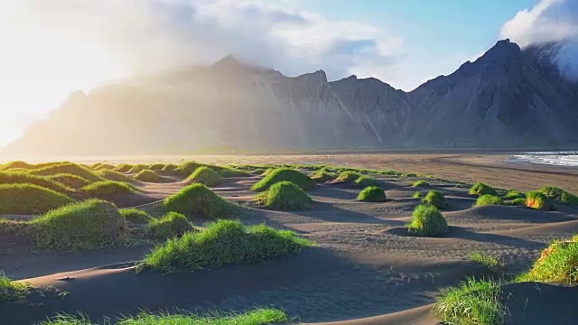 冰岛斯托克尼斯海滩上的山脉和火山熔岩沙丘的奇妙西部